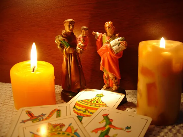 Altar espiritual con veladoras y figuras sagradas para rituales de amarres de amor